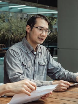 Adult professionals discussing business strategies in an outdoor setting.